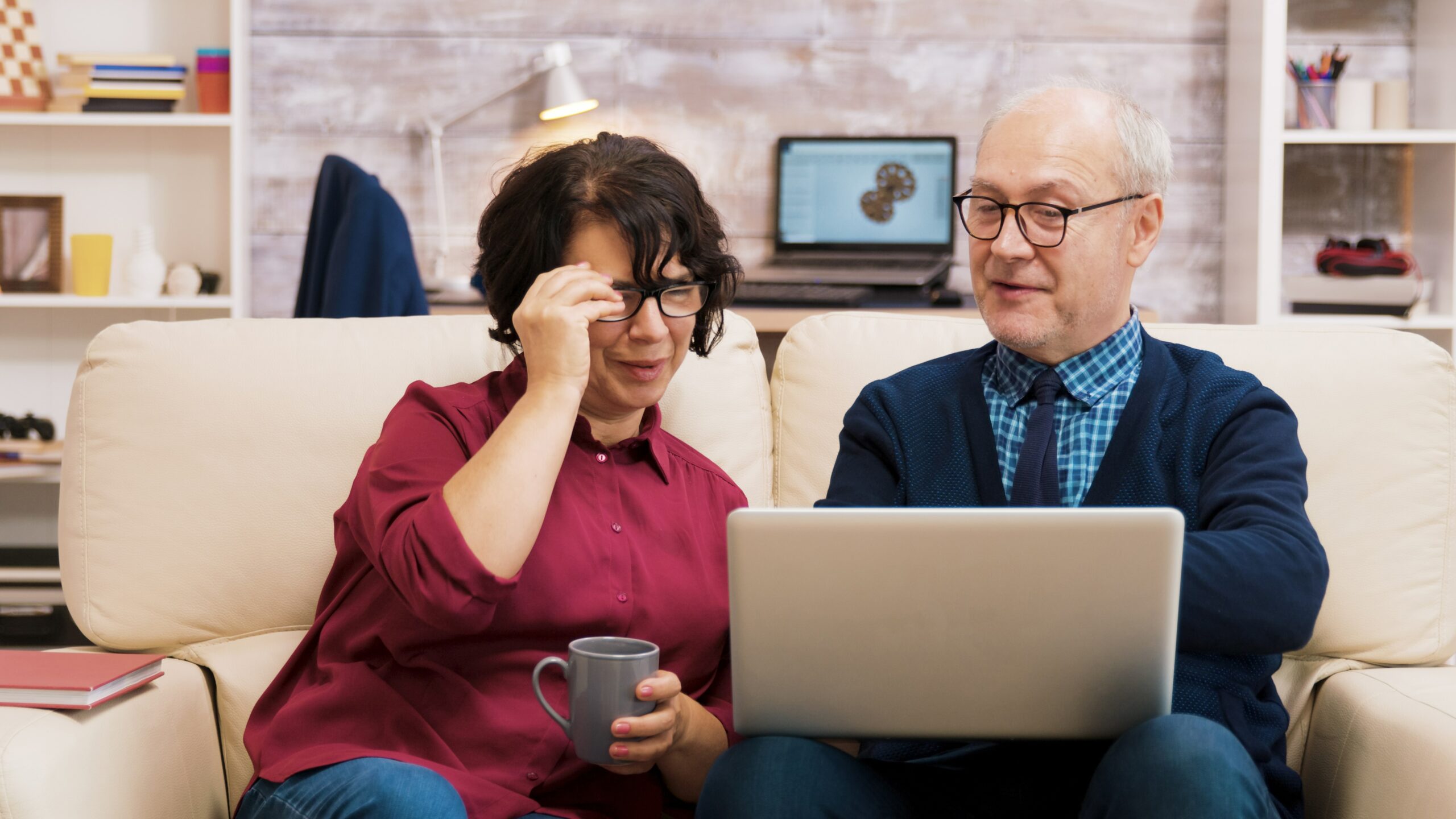 Elderly visually impaired Couple working on a laptop with Screen reader turned on.